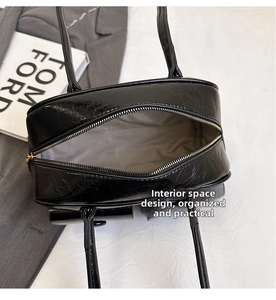 Detailed top view of the black oil wax leather handbag's spacious interior and zipper