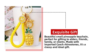 Detail of pineapple keychain with yellow opal beads and gold-toned lucky coin charm