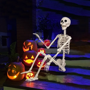 Life-size 165cm posable Halloween skeleton decoration with pumpkins on night porch