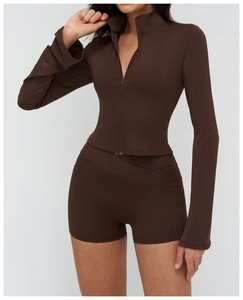 Detail of dark brown slim fit yoga jacket with stand collar and zipper closure design