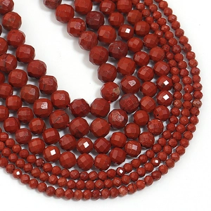 Detailed view of faceted red natural stone beads in layered necklaces for DIY jewelry