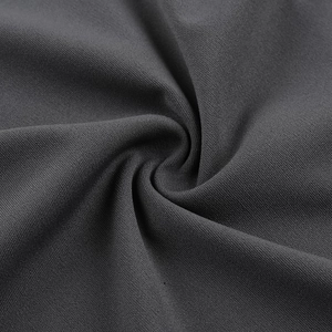 Gros plan sur la texture du tissu en maille gris foncé avec tissage fin et drapé élégant