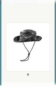 Close-up of camouflage bucket hat with metal eyelets and adjustable chin strap
