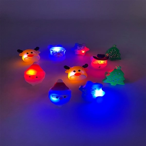 Colorful LED glowing Christmas rings featuring Santa Claus and snowman soft rubber designs