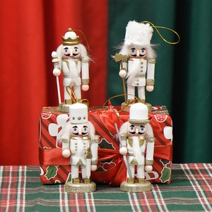 Set of four 10cm white and gold wooden nutcracker soldier ornaments with glitter and cords