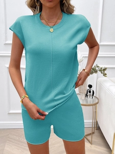 Detail of teal knit two-piece set featuring cap-sleeve top and high-waisted shorts