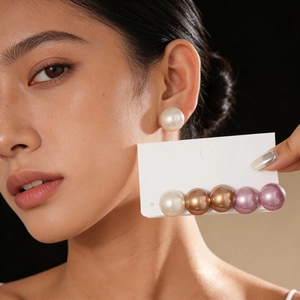 Close-up of 6-piece large round pearl stud earrings set in multiple elegant colors