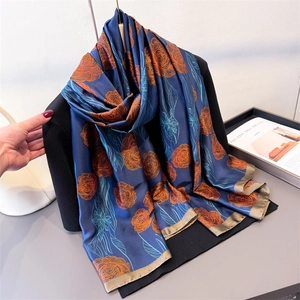 Floral satin silk scarf in navy blue with orange rose print and champagne trim