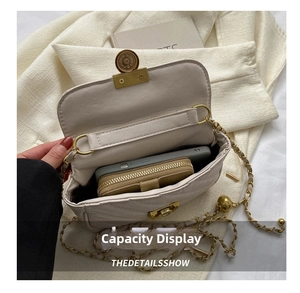 Detail showing inner capacity of beige quilted crossbody bag with phone and wallet