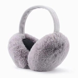 Detailed macro view of soft gray plush faux fur earmuffs with matching fabric headband