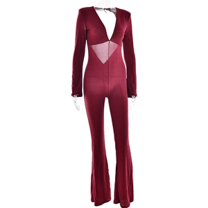 Front view of red long sleeve jumpsuit with deep V-neck, mesh waist and flared legs