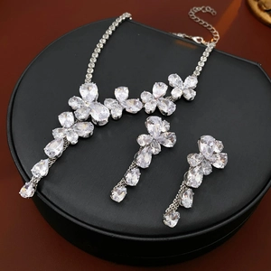 Macro shot of silver zircon flower and teardrop necklace and earring jewelry set