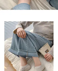 Dettaglio di calzini bassi a pois azzurri abbinati a pantaloni in denim a gamba larga