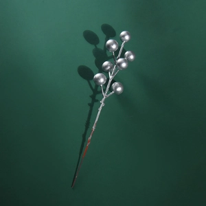 Macro detail of artificial silver glitter berry branch for Christmas desktop decoration