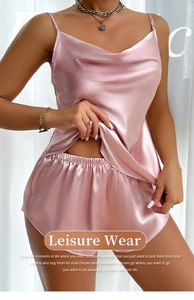 Detail view of pink satin two-piece sleepwear set with camisole and side slit shorts