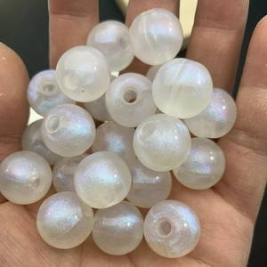 Close-up of luminous iridescent pearl round beads with center holes for DIY jewelry