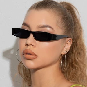 Modern black rectangle sunglasses with dark lenses on a model for a chic street style look