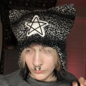 Detailed close-up of chunky knit cat ear beanie with star pattern and punk aesthetic