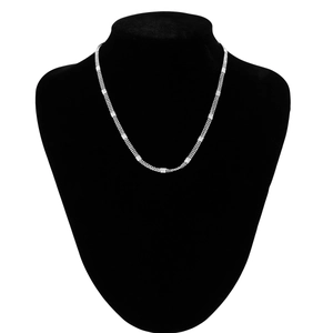Detail of silver multi-layer body chain with textured square accents on velvet display