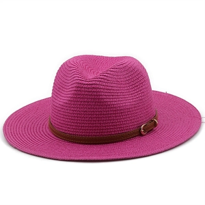 Close-up of bright rose straw fedora with brown faux leather belt and gold buckle detail