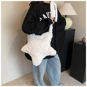 Close-up of a plush white star-shaped crossbody bag featuring soft fuzzy sherpa texture