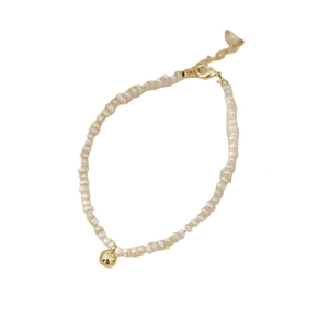 Detail of natural pearl bracelet with golden sphere pendant and clasp on white background