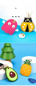 Detailed view of cartoon leather AirTag holders with metal keyring and card slot