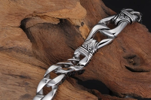 Close-up of vintage silver stainless steel chain bracelet with intricate floral engravings