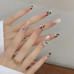 Long coffin leopard print press-on nails with golden glitter and luxury rhinestones