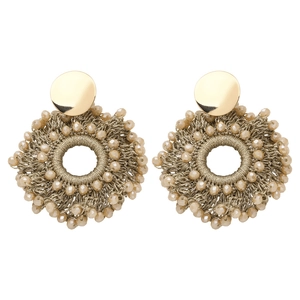Macro shot of handmade woven seed bead earrings with golden hoops and crystal facets