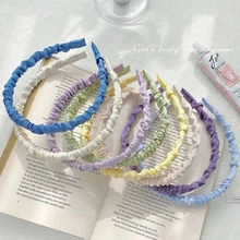 Colorful ruffled headband set on a book showcasing pastel fabric texture and soft aesthetic