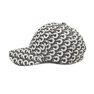 Side view of baseball cap featuring iconic black and white crescent moon print patterns