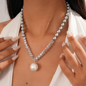 Detail of beaded necklace with grey pearls, clear crystals and large white pearl pendant