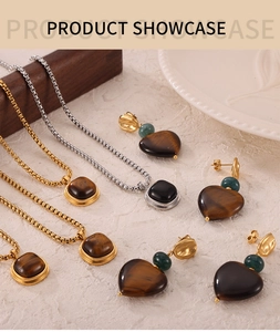 Detail of vintage heart and square tiger eye stone jewelry set in gold and silver finish