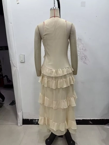 Detail of light beige sleeveless midi dress featuring elegant layered chiffon ruffles