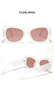 Detail view of large jelly white frame sunglasses with red-brown lenses and wide temples