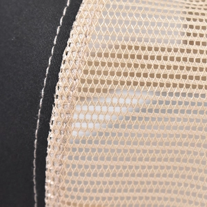 Macro detail of high-quality mesh stitching and cotton fabric on trucker hat