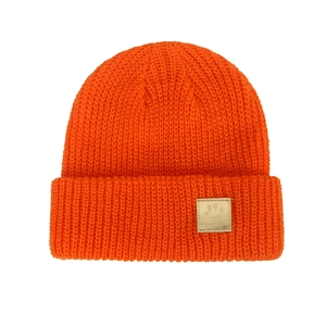 Detailed knit texture and gold smiley face logo on an orange winter beanie for infants