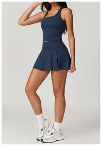 Detail of navy blue sports set with tight top and side-slit tennis skirt for fitness