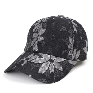 Detailed close-up of floral lace pattern on the side of a breathable mesh baseball cap