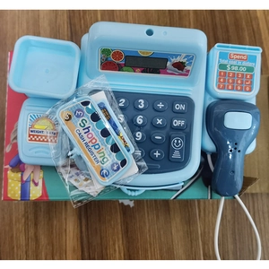 Blue kids toy cash register playset with scanner and accessories on wooden table