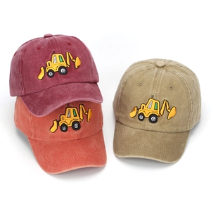 Detail of excavator embroidery on washed cotton baseball caps in multiple colors