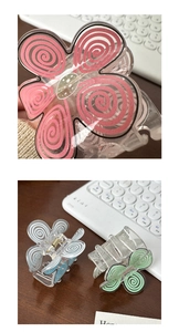 Macro view of macaron pink floral hair claw clip and detail of acrylic spiral pattern