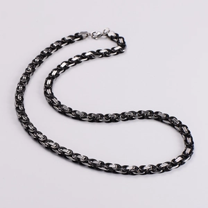 Detail of two-tone black and silver stainless steel Byzantine chain necklace with lobster clasp