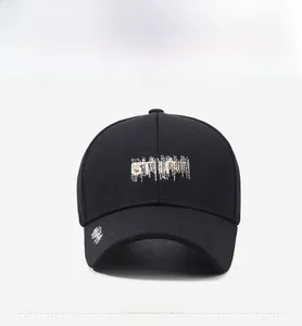 Close-up of STARS embroidery and distressed white stitching on black cotton baseball cap