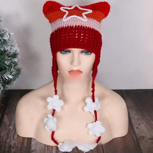 Detail of red and orange gradient crochet knit hat with cat ears and star patch