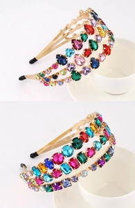 Detailed close-up of Baroque gold headband with multicolored rhinestones and crystals