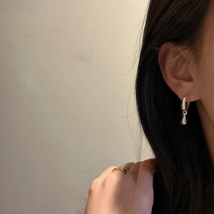 Elegant S925 sterling silver hoop earrings with water drop pendants on model's ear