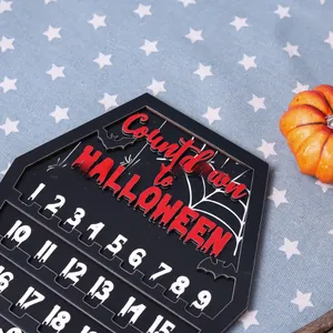 Detail of wooden Halloween countdown calendar featuring bat and spider web decorations