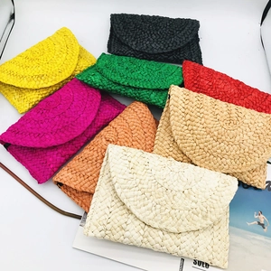 Handwoven corn husk straw clutch bag for women in multiple vibrant colors and textures